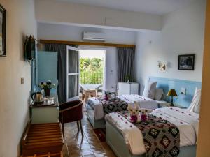 Postel nebo postele na pokoji v ubytování El Gezira Hotel