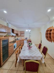 a kitchen with a table and chairs in a kitchen at Квартира in Astana