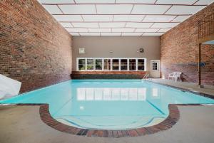 a large indoor swimming pool with a brick wall at Red Roof Inn Chattanooga - Lookout Mountain in Chattanooga