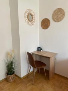 a desk and a chair in a room at City Garden Apartment in Plovdiv