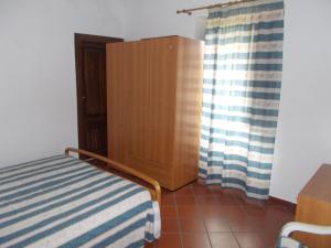 A bed or beds in a room at Casa Vacanze Liperni