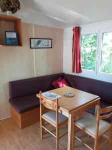 a living room with a couch and a table at Mobil Home Saint Paul lès Dax in Saint-Paul-lès-Dax