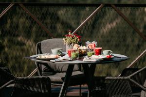 a table with plates of food on a patio at Aparthotel My Daum in Nova Ponente