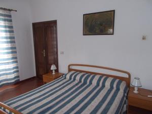A bed or beds in a room at Casa Vacanze Liperni