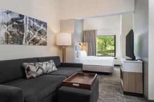 a living room with a couch and a bed at SpringHill Suites West Mifflin in West Mifflin
