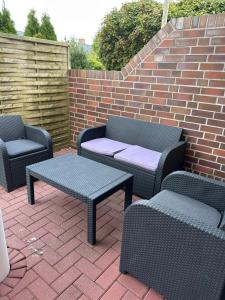 a patio with two chairs and a table and chairs at Sternschnuppe in Borkum