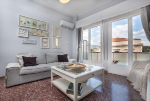 un salon avec un canapé et une table dans l'établissement Cosy Apartment With Acropolis View, à Athènes