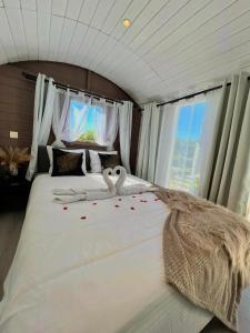 a bedroom with a bed with a stuffed animal on it at Le Clos fleuri in Fauvillers