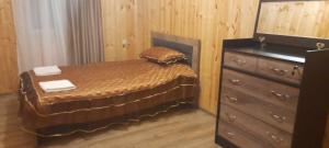 a bedroom with a bed next to a dresser at Marekhi guest house in Sagarejo +8 photos