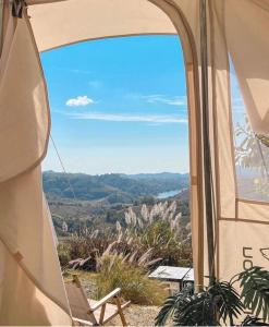 a room with a chair and a view of the ocean at Papa Garden Khaokho in Khao Kho