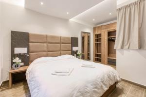 a white bedroom with a large bed and a window at Bluebell Apartment-Hosted by Sweetstay in Sliema