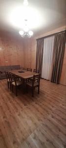 a large room with a wooden table and chairs at Marekhi guest house in Sagarejo