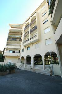 a large building with stairs in front of it at la palme d or in Saint-Raphaël