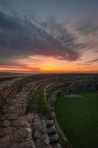 a stone wall with a sunset in the background at Castleview in Milltown