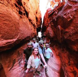 a group of people standing in a canyon at Moon city camp in Wadi Rum