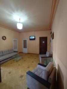 a living room with two couches and a tv at Sun city hostel in Yerevan