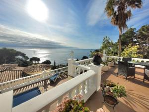 a white balcony with a view of the ocean at La Marina in Lloret de Mar