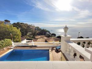 a villa with a swimming pool and a view of the ocean at La Marina in Lloret de Mar
