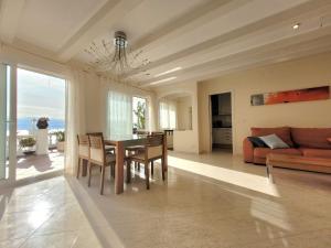 a living room with a table and chairs and a couch at La Marina in Lloret de Mar