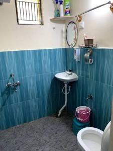 a bathroom with a sink and a toilet at Sattva Farmstay in Bangalore