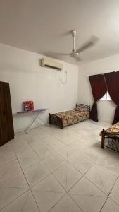 a living room with a bed and a ceiling fan at New Furnished Apartment in Djibouti