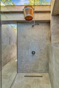 a bathroom with a shower with a glass door at Хотел Чудните Мостове in Zabŭrdo