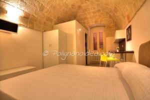 a bedroom in a house with a bed and a table at B&b Monopoli Old Town in Monopoli