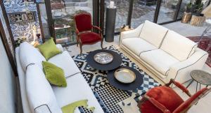 a living room with two white couches and a table at La Maison Ruffinoise in Sainte-Ruffine