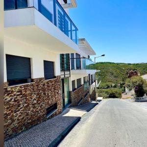 an empty street in front of a building at Zambujeiraseahouse - 100m da praia in Zambujeira do Mar +18 photos