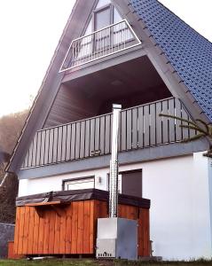 倫山比紹夫斯海姆的住宿－Ferienhaus in der Rhön Sitzmann，房屋设有甲板和阳台