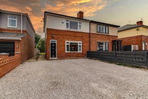 a brick house with a driveway in front of it at The Collier's Rest: 3 bed home in South Yorks with parking & garden. in Barnsley