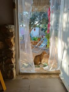 a cat sitting in the doorway of a door at Cala Creta in Lampedusa