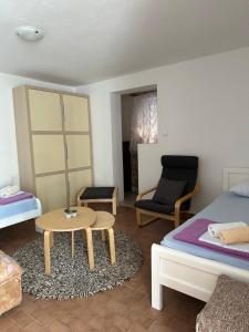 a bedroom with a bed and a table and a chair at Apartments Suzana in Herceg-Novi