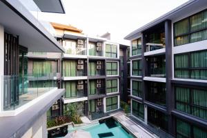 an external view of a building with a swimming pool at B507-top Floor Pool View 1 Br At Ao Nang Beach in Ao Nang Beach