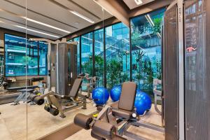a gym with cardio equipment and a large window at B507-top Floor Pool View 1 Br At Ao Nang Beach in Ao Nang Beach