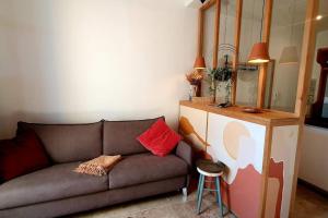 a living room with a couch and a mirror at la Perle Rare - Centre-Ville in Sète +15 photos