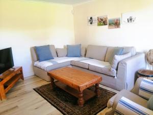 a living room with a couch and a coffee table at Adrenalin Addo Manor House in Addo