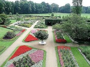 a garden with red and pink flowers and a pathway at *RB7C* For your most relaxed & Cosy stay + Free Parking + Free Fast WiFi * in Batley