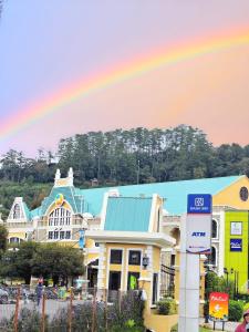 a rainbow in the sky above a gas station at VILLA BUKIT MAS BERASTAGI DEPAN MIKIE FUNLAND in Berastagi