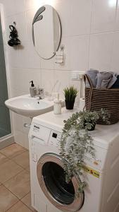 a washing machine in a bathroom with a sink at Best Apartment in the Center in Mukacheve