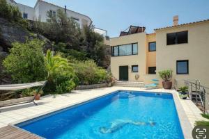 a swimming pool in front of a house at CasaLeo HARRY - Roses / Costa Brava in Roses