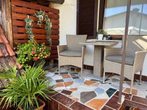 a patio with a table and chairs and flowers at Rooms Horvat in Krapina
