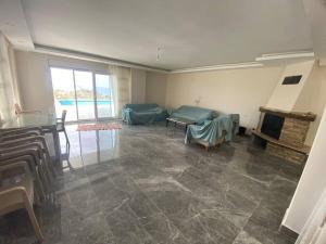 a living room with a table and a fireplace at Villa Venus in Gazipasa