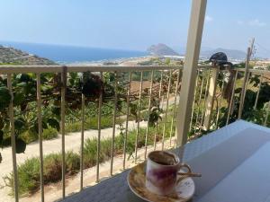 a cup of coffee sitting on a table on a balcony at Villa Venus in Gazipasa