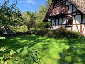 a yard next to a house with green grass at Kleine Ferienvilla in Frankenau in Frankenau
