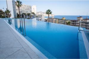a large blue swimming pool on top of a building at Apartment Sunset Cliffs Poniente in Benidorm
