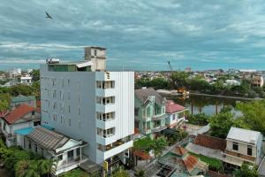 an aerial view of a city with a white building at Vina Hotel Hue in Hue