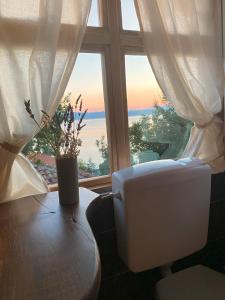 a toilet sitting in front of a window at Robinson Sunset Guest House in Ohrid