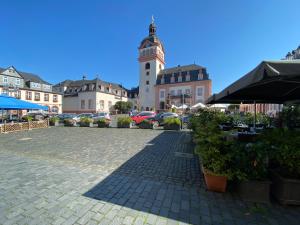a town square with a clock tower in the background at Weilburg-Domizil in Weilburg