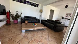 a living room with a couch and a coffee table at La Villa Miranda Meublé de Tourisme 4 * in Saint-Gilles-les-Bains